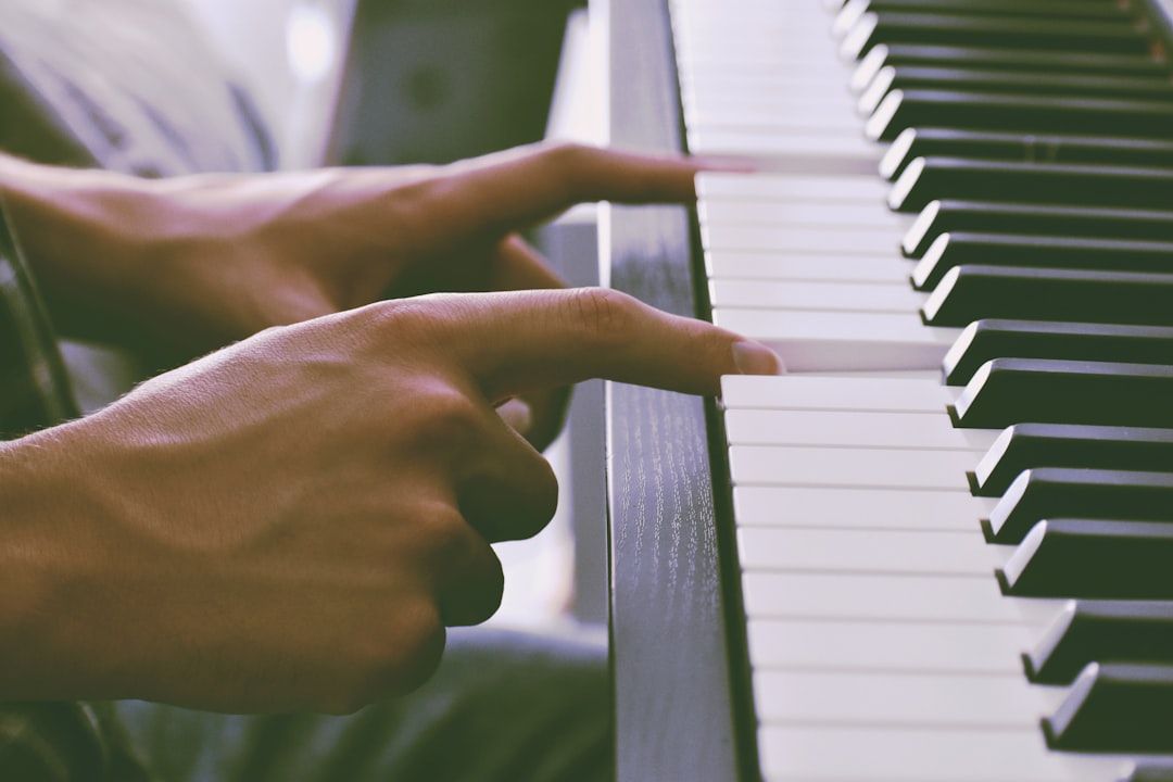 person's finger on piano