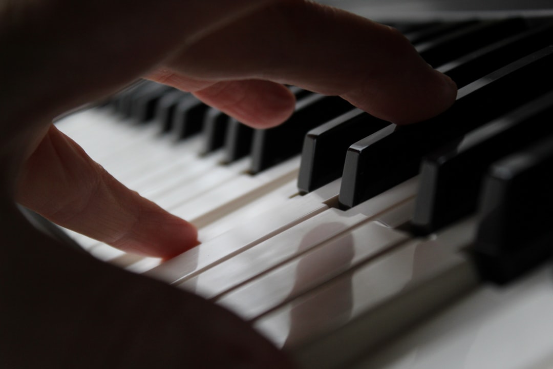 people's hands on piano keys