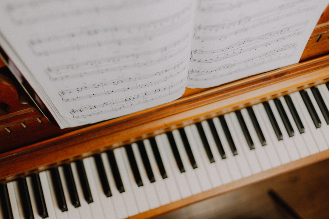 musical notes on brown upright piano