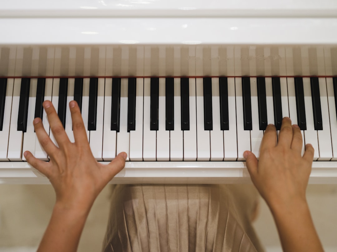 a person's hands on a piano keyboard