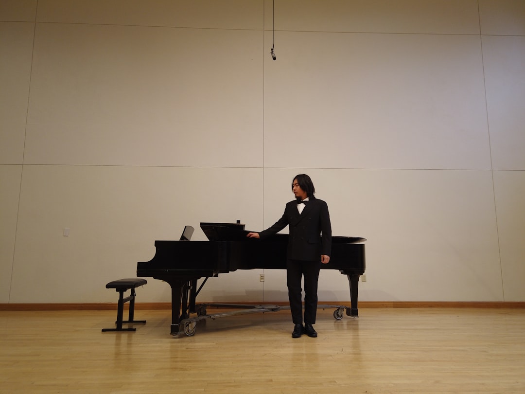A man in a tuxedo playing a piano