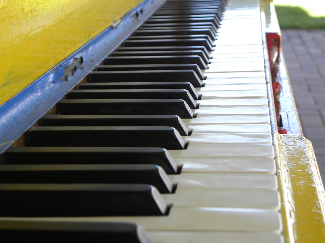 A close up of a piano with yellow and black keys