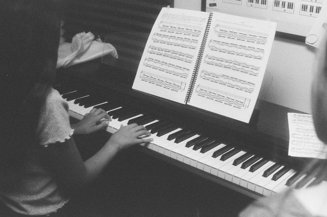 Two children learning to play the piano together.