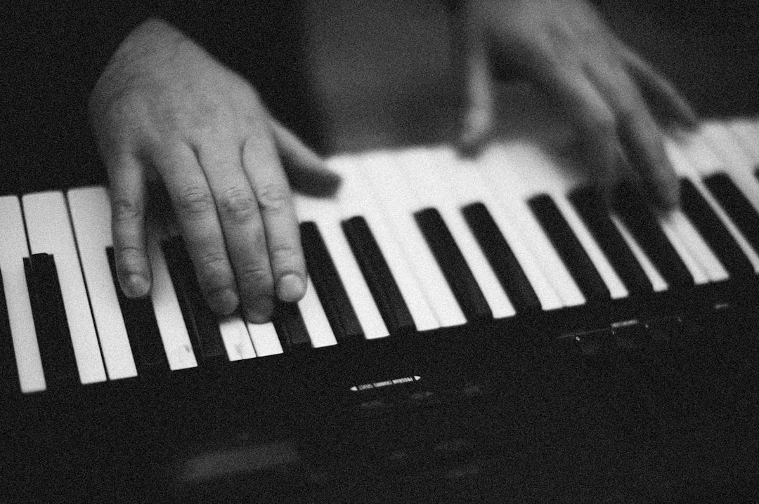 a person's hands on a piano keyboard