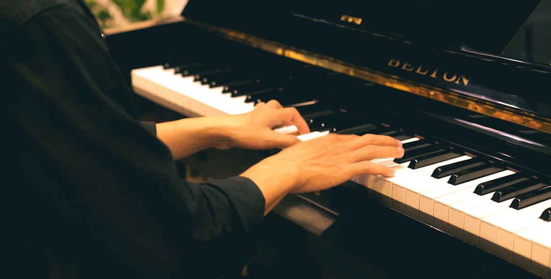 a person playing a piano with their hands