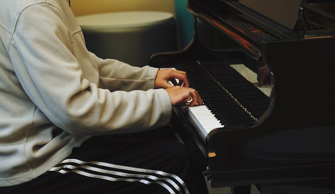 a man sitting at a piano playing a musical instrument