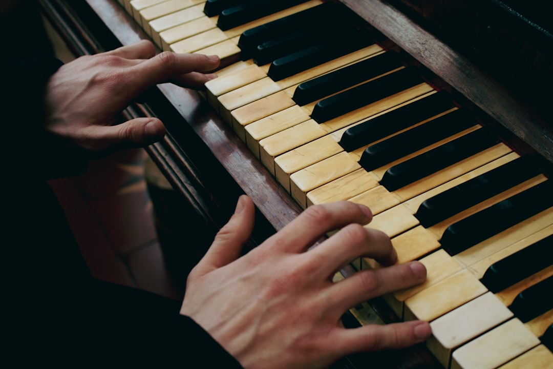 A person playing a piano with their hands